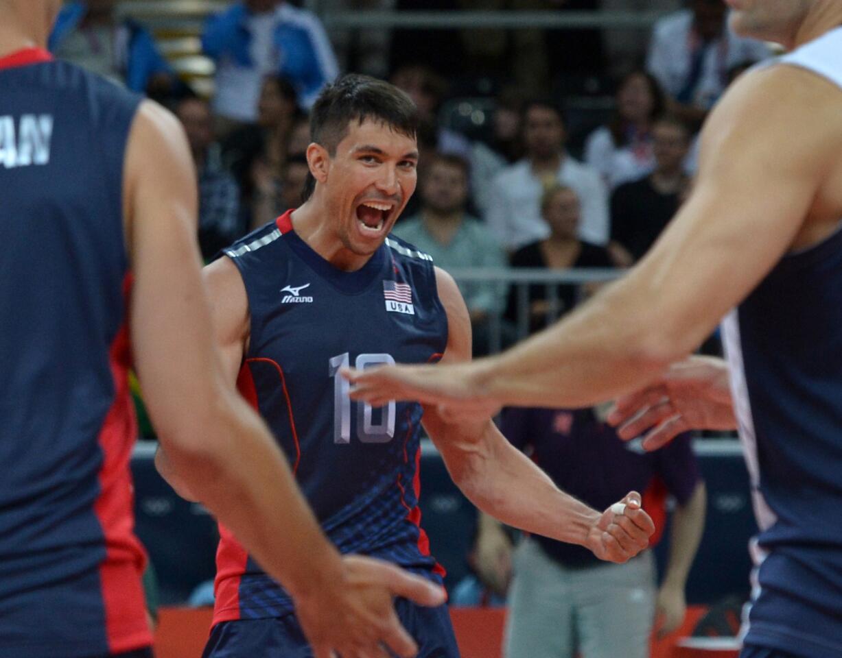 David McKienzie of the United States celebrates a victory over Tunisia in a men's preliminary volleyball match won by the Americans, 3-0.