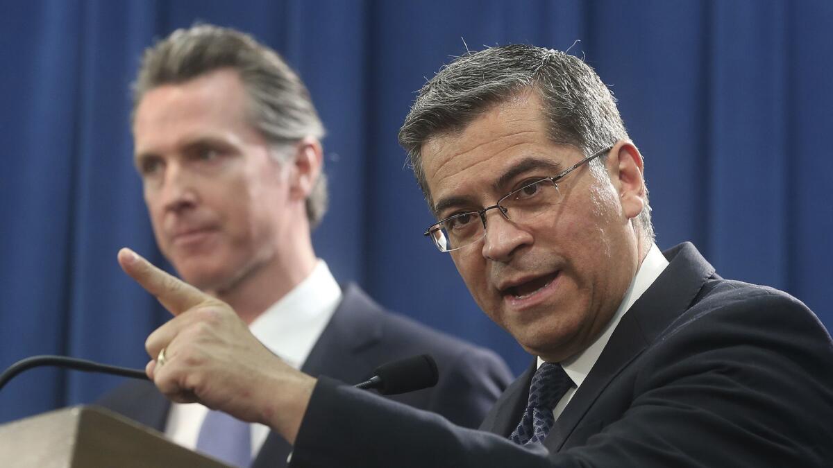 California Atty. Gen. Xavier Becerra, right, filed a federal lawsuit Monday against the Trump administration stemming from the recent national emergency.