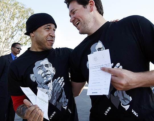 Ben Davis, left, of Costa Mesa, and Rob Stonecipher, of L.A., share their excitement over getting tickets to see President Obama at the Orange County Fairgrounds.