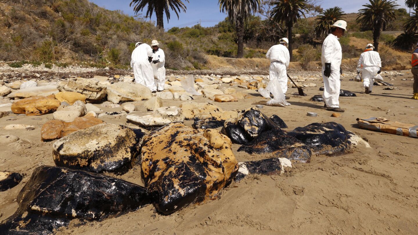 Oil covers rocks at Refugio State Beach on Wednesday.