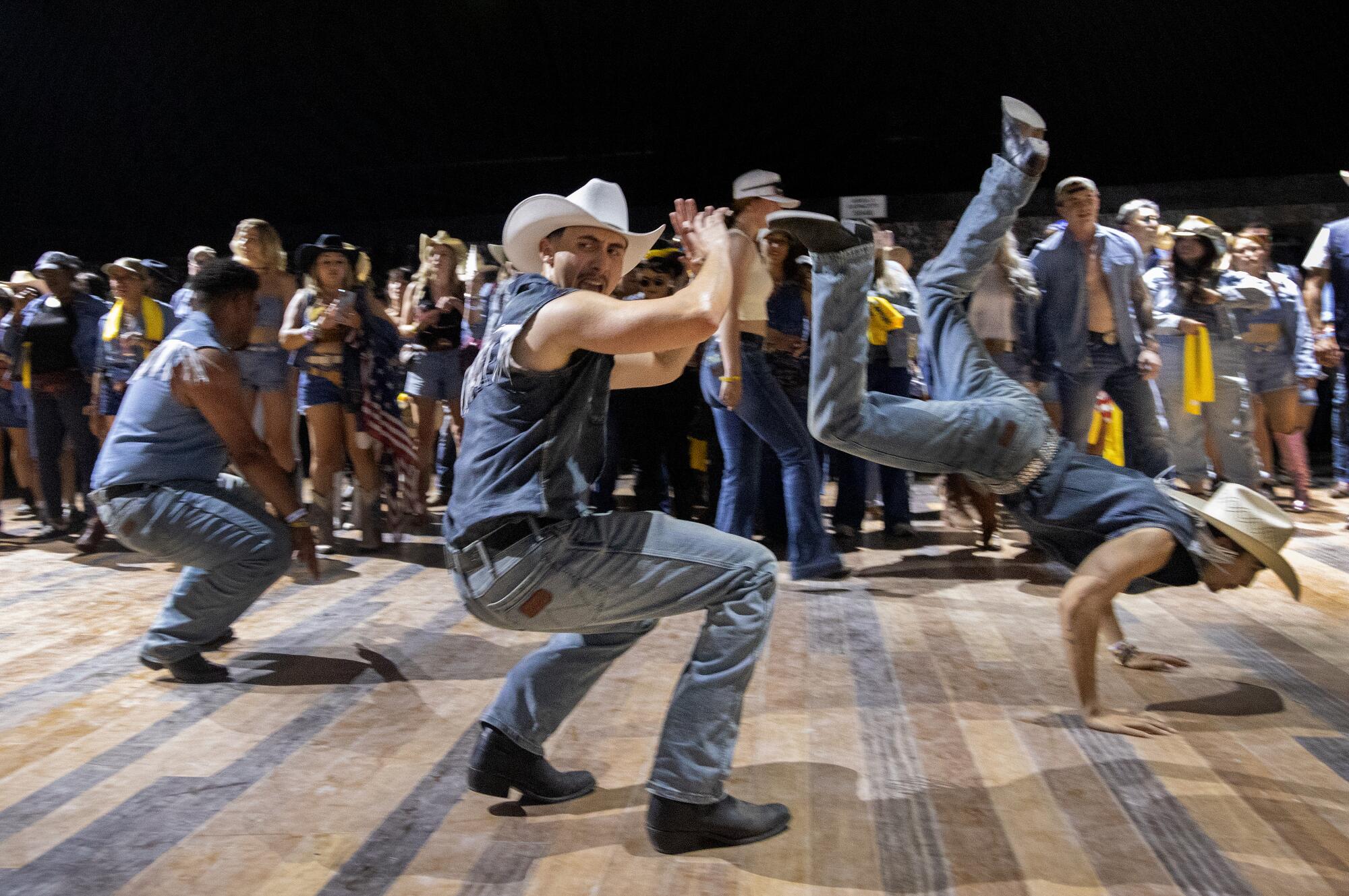 Country dancers perform before a crowd to DJ Kevin Bolt at Diplo's Honkytonk.
