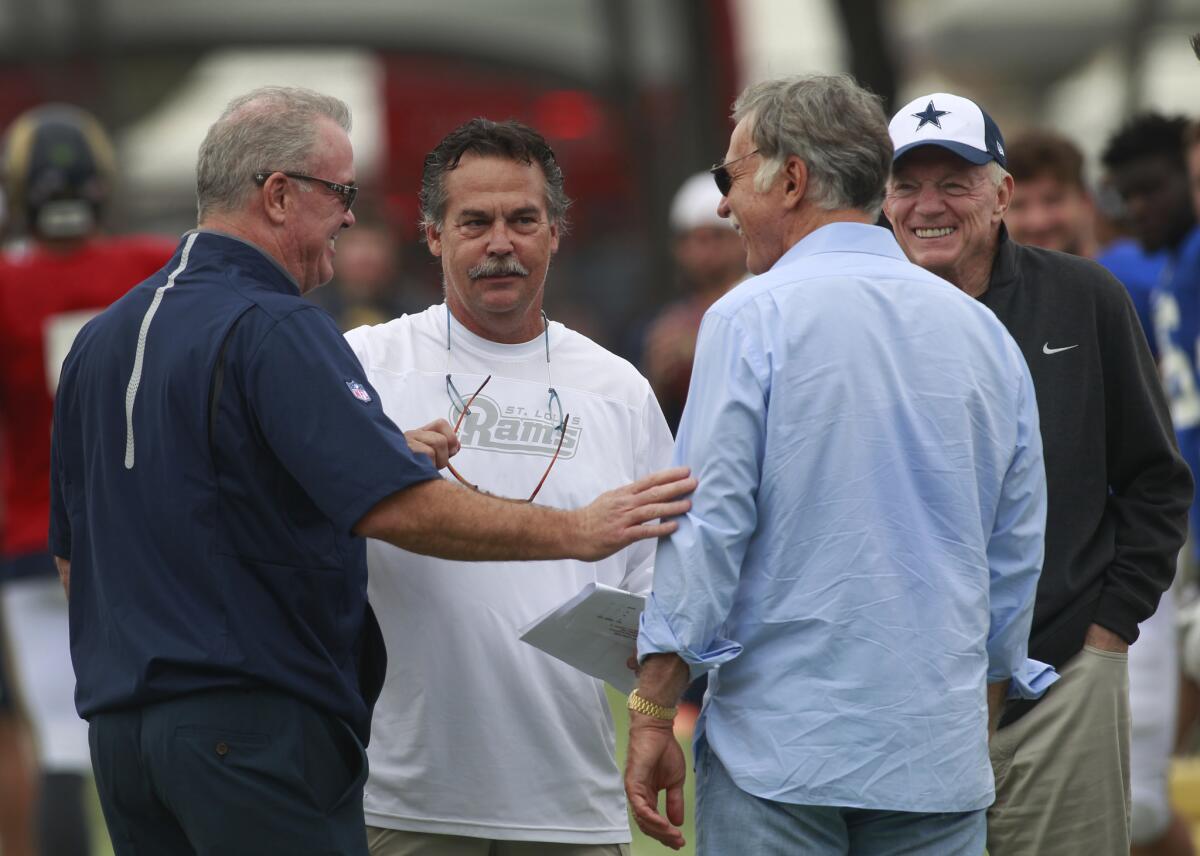 Dallas Cowboys executive vice president Stephen Jones, left, Rams Coach Jeff Fisher, Rams owner Stan Kroenke and Cowboys owner Jerry Jones talk during joint training camp in Oxnard on Aug. 17, 2015.