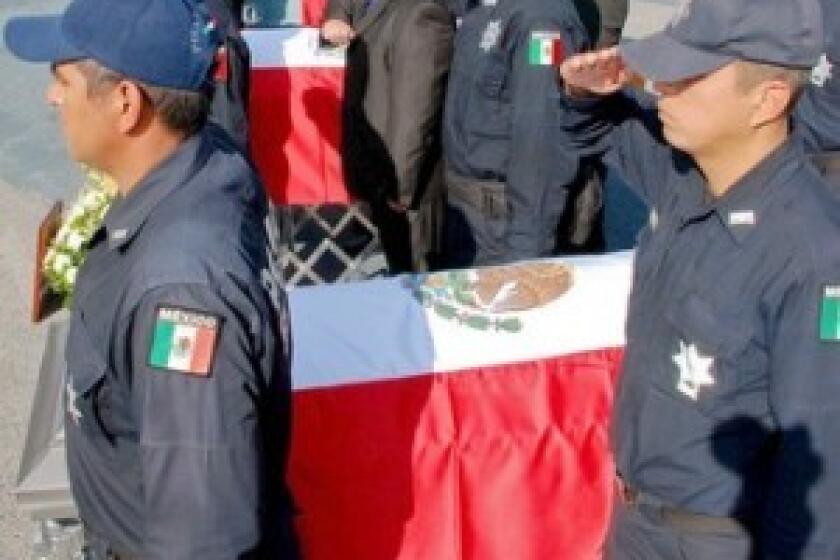 Federal police participate this week in the Mexico City funeral for 12 fellow officers whose bodies were found in a heap in the western state of Michoacan. The La Familia drug gang is suspected of killing them.