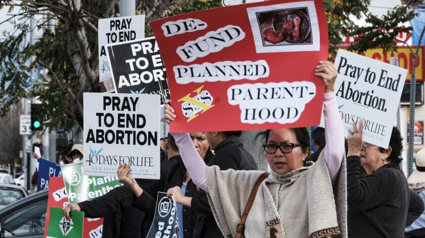 Anti-abortion protesters carry signs outside a Planned Parenthood clinic in Van Nuys in 2017.