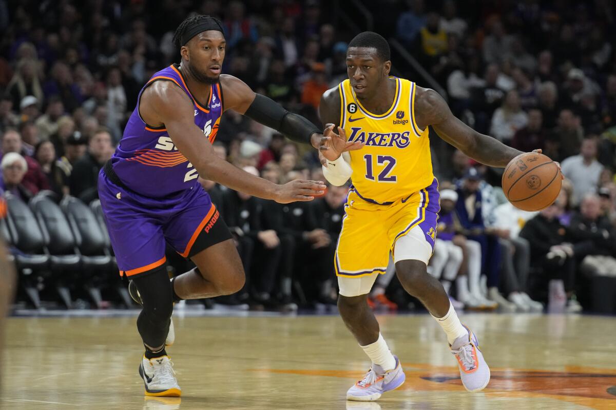 Lakers guard Kendrick Nunn, right, controls the ball against the Phoenix Suns on Dec. 19.