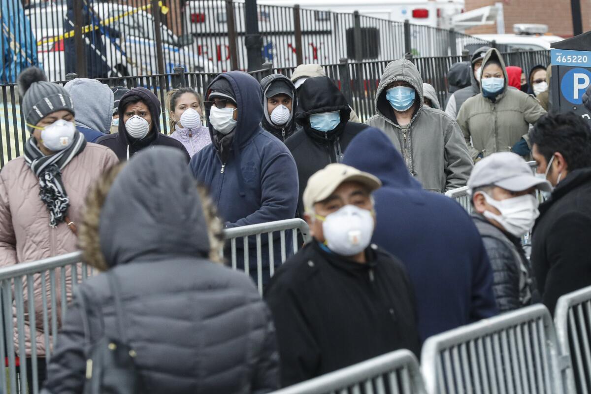 People wait in line for a COVID-19 test at Elmhurst Hospital in New York City