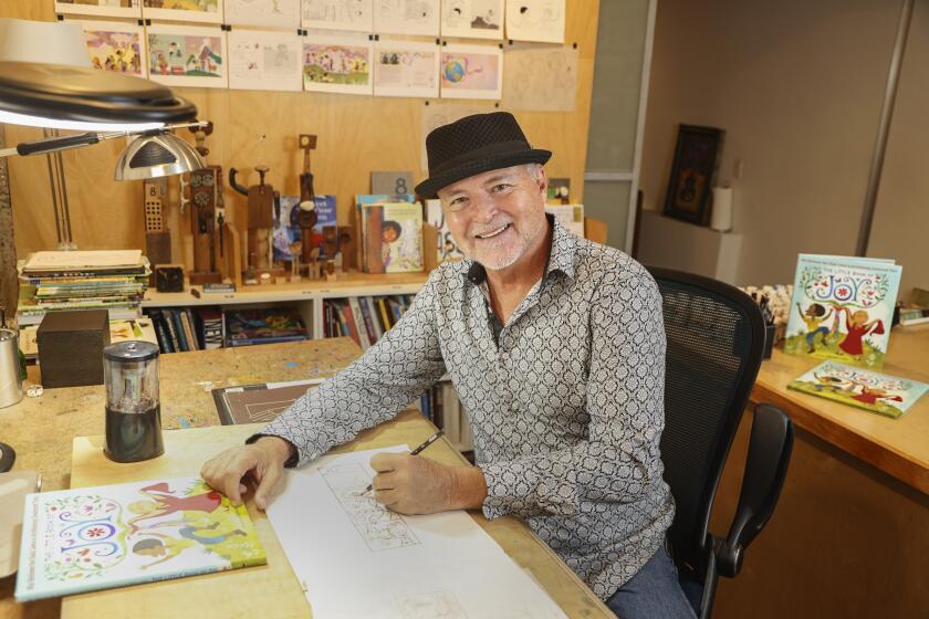 San Diego, CA - October 05: Artist and book illustrator Rafael Lopez poses for photos in his studio on Wednesday, Oct. 5, 2022 in San Diego, CA. (Eduardo Contreras / The San Diego Union-Tribune)