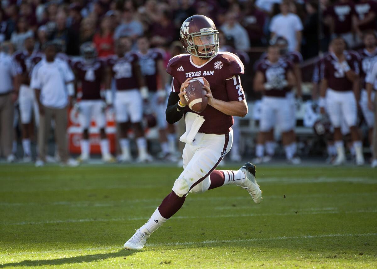 Johnny Manziel rolls out to throw a touchdown pass against Sam Houston State in College Station, Texas.