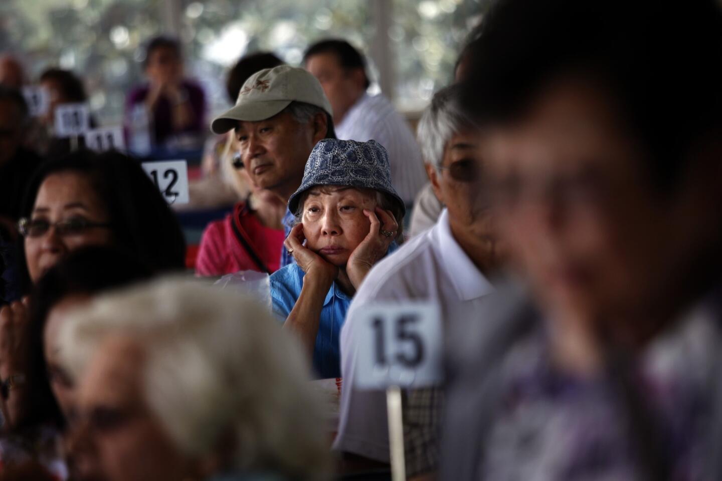 At a reunion at Santa Anita Park in Arcadia, Setsuko Nomura, 78, center, joins fellow Japanese Americans who were interned at the track's "assembly center" 72 years ago.