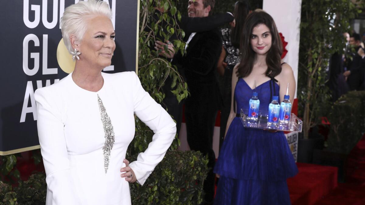 "Fiji Water Girl" Kelleth Cuthbert photo-bombs Jamie Lee Curtis at the 76th Golden Globe Awards last month.