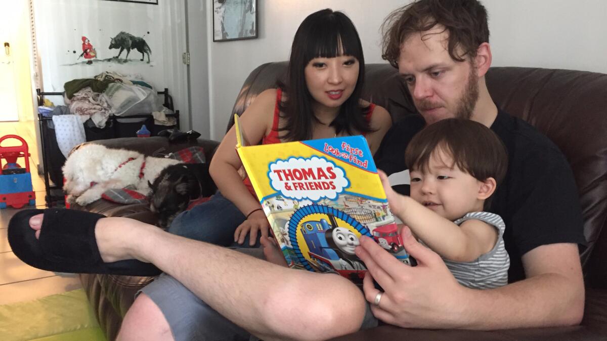 Sherrie Varpula-Walter and her husband, Matt Walter, read to their 2-year-old, Jack. She is pregnant and spends most of her time holed up in the family's Miami apartment to avoid being infected with Zika.