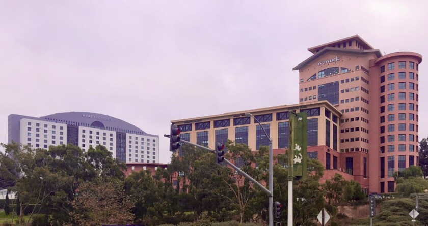To the right of the recently repainted Hyatt Regency La Jolla hotel is the rotunda and office complex in the original colors.