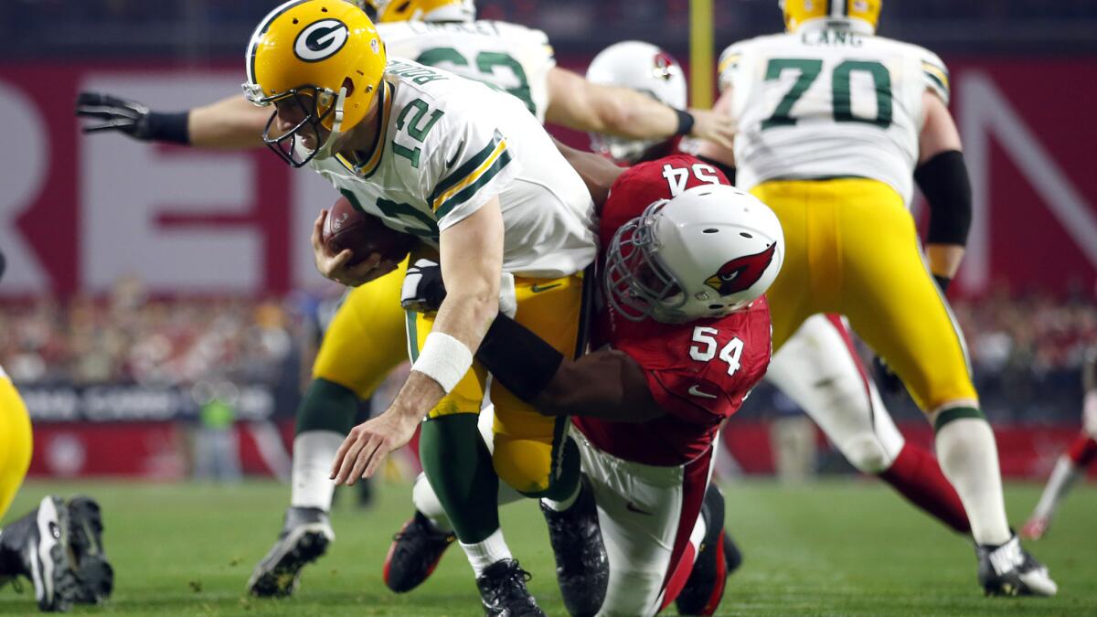 Packers quarterback Aaron Rodgers (12) was sacked eight times when they played the Cardinals on Dec. 27, including this one by linebacker Kenny Demens.