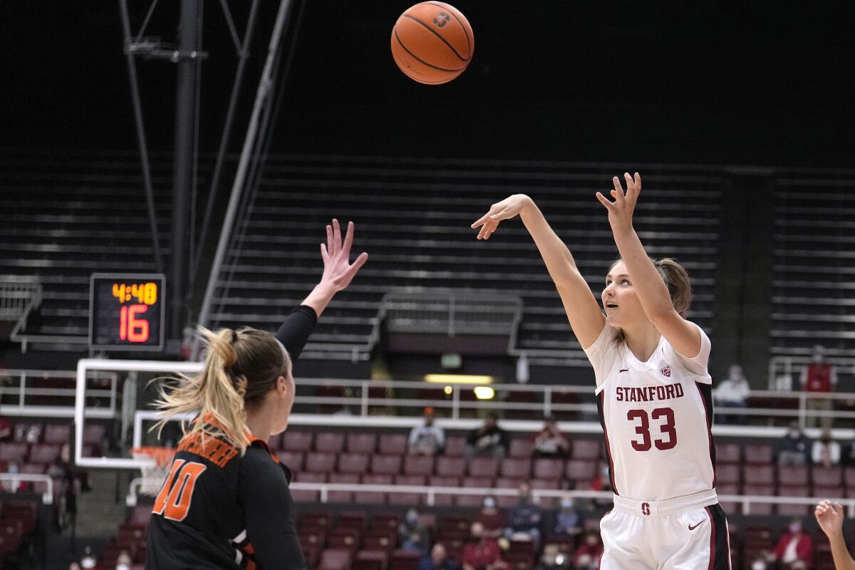 Stanford guard Hannah Jump (33) takes a 3-point shot over Oregon State guard Greta Kampschroeder (10) during the first half of an NCAA college basketball game in Stanford, Calif., Wednesday, Feb. 9, 2022. (AP Photo/Tony Avelar)