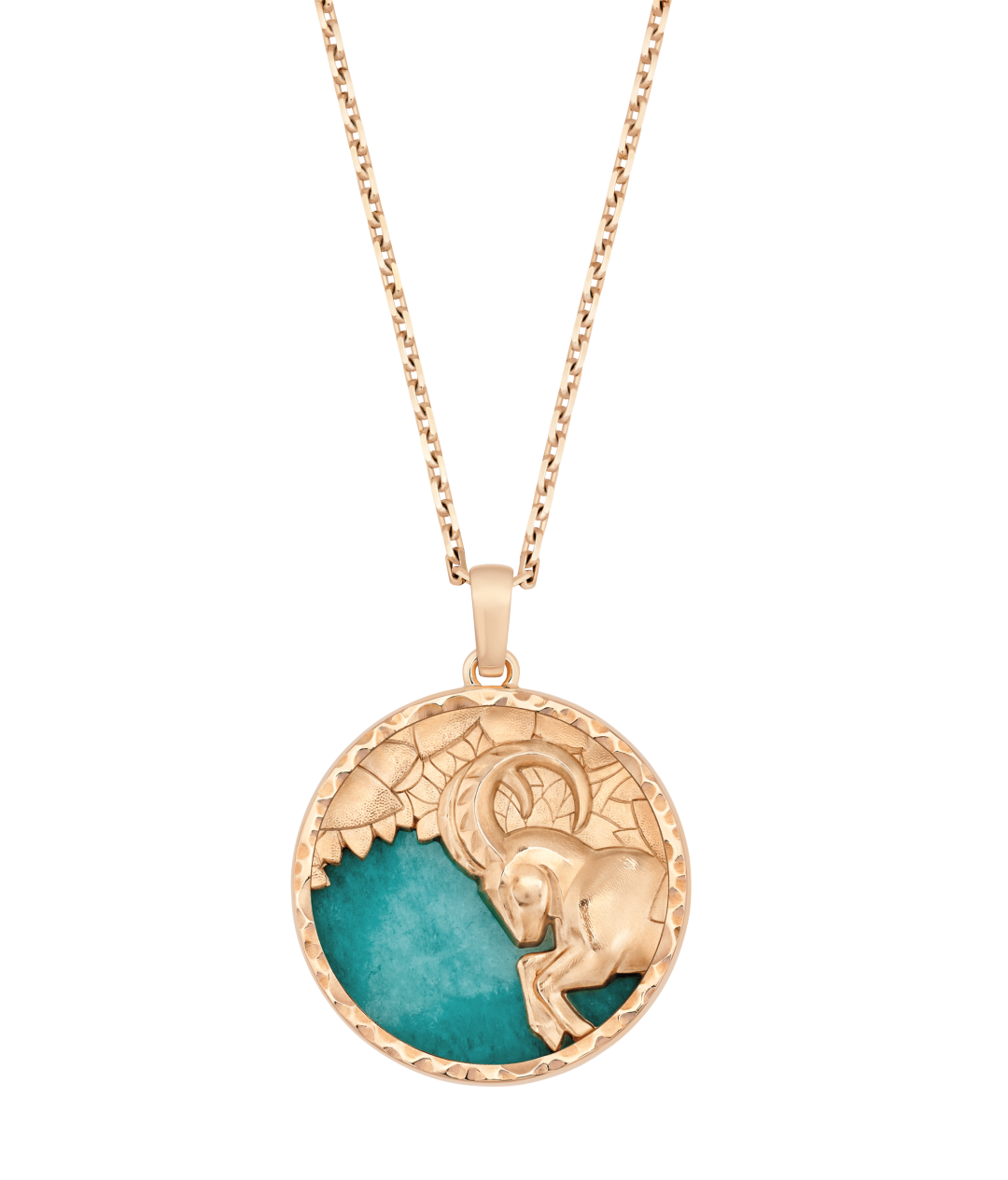 A round pendant necklace represents a Capricorn goat in gold on a green background.