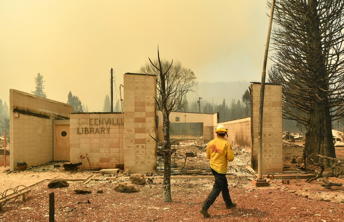 A firefighter surveys what remains of the Greenville Library.