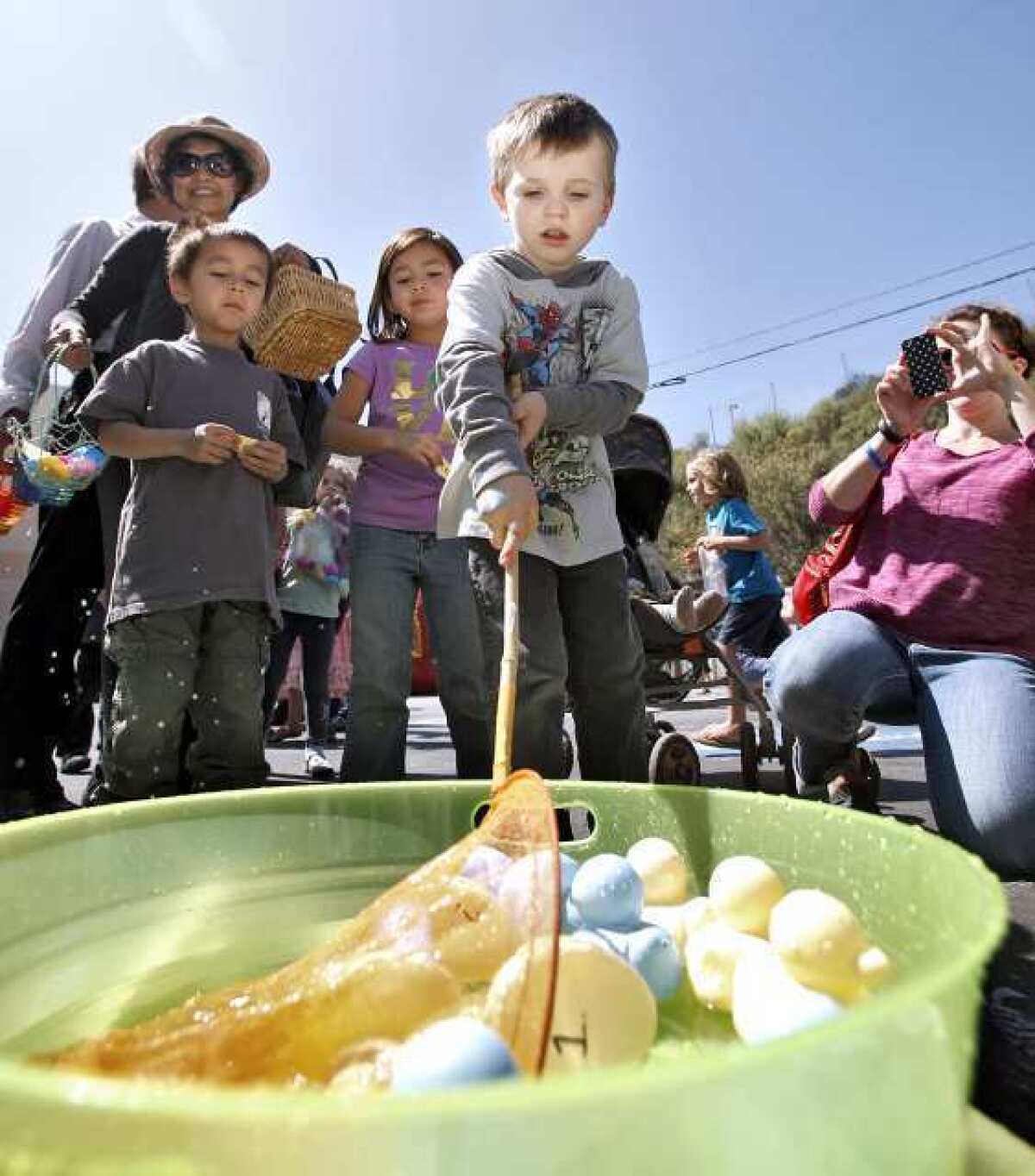 Isacc Porath, 4 of La Crescenta, fishes for ducks and a prize at the Crescenta-Canada Family YMCA's second annual Easter Egg Hunt and Carnival in La Canada Flintridge.