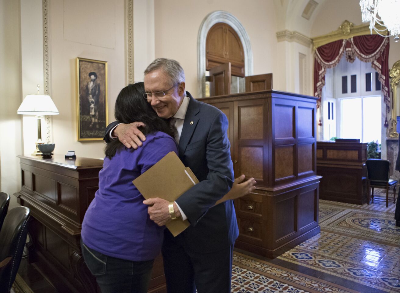 Senate Majority Leader Harry Reid (D-Nev.) embraces Astrid Silva of Las Vegas, a Dream Act supporter whose family came to the U.S. from Mexico illegally and whose story has been an inspiration for Reid during work on the immigration reform bill.