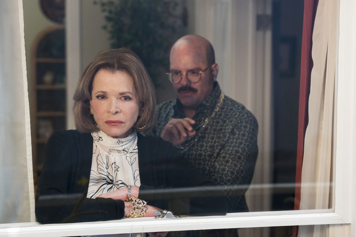 Jessica Walter and David Cross peering out of a window in "Arrested Development."