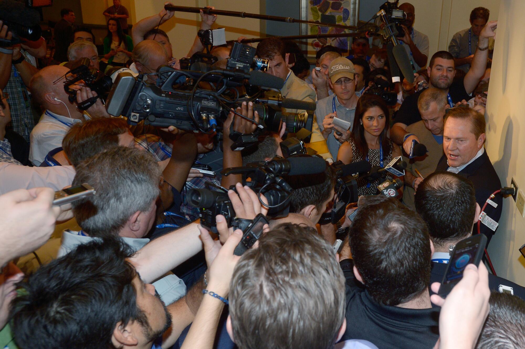 Scott Boras, right, talks to the media at baseball's winter meetings in Lake Buena Vista, Fla., in 2013.