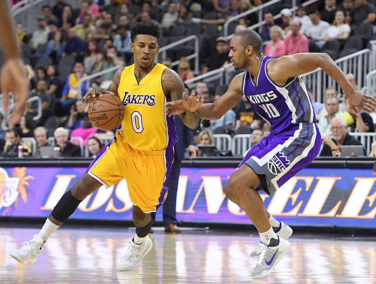 Lakers forward Nick Young (0) drives against Sacramento Kings guard Arron Afflalo during a preseason game in Las Vegas on Oct. 13.