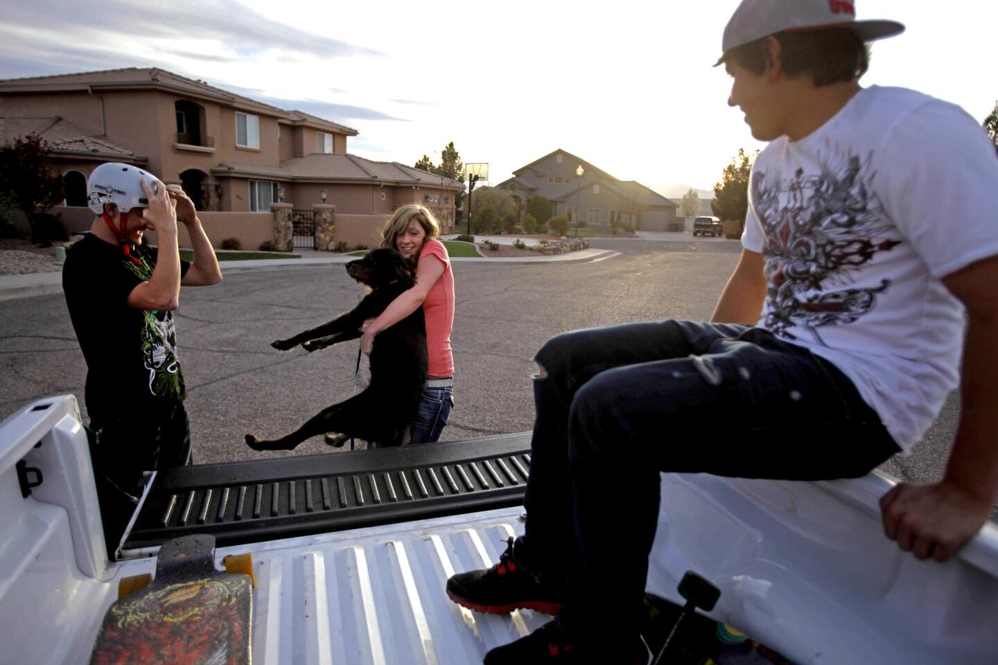 Zach Bowers, 18, left, and his half-brother Isaiah, 17, with their older brother Caleb's fiancee, Paige Siler, and the family dog. The young men have left their nearby polygamist compound in Arizona.
