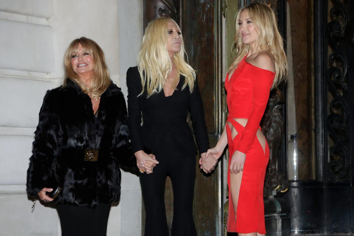 From left, Goldie Hawn, Italian fashion designer Donatella Versace and Kate Hudson at Atelier Versace's spring-summer 2015 haute couture fashion collection in Paris on Sunday.