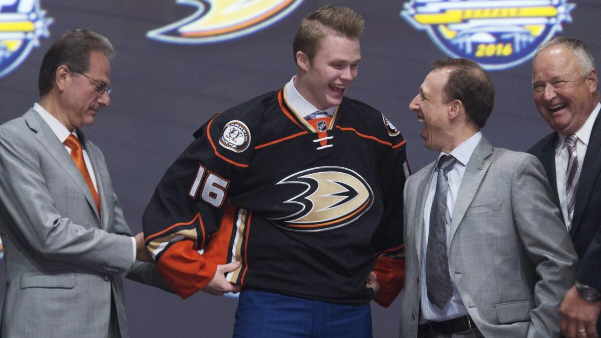 Max Jones is shown with members of the Ducks' management team at the NHL draft.