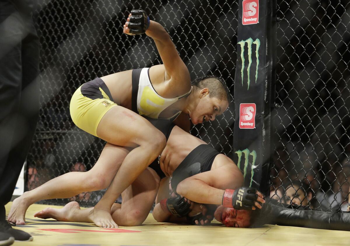 Amanda Nunes, left, fights Miesha Tate during their women's bantamweight championship mixed martial arts bout at UFC 200, Saturday, July 9, 2016, in Las Vegas. (AP Photo/John Locher)