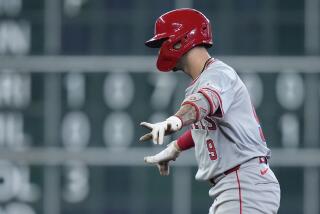 Los Angeles Angels' Zach Neto celebrates after hitting a three-run double during the ninth inning of a baseball game against the Houston Astros, Sunday, Sept. 22, 2024, in Houston. (AP Photo/Kevin M. Cox)