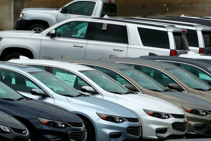 Trucks are moving; cars aren't. A dealer lot in Pittsburgh.