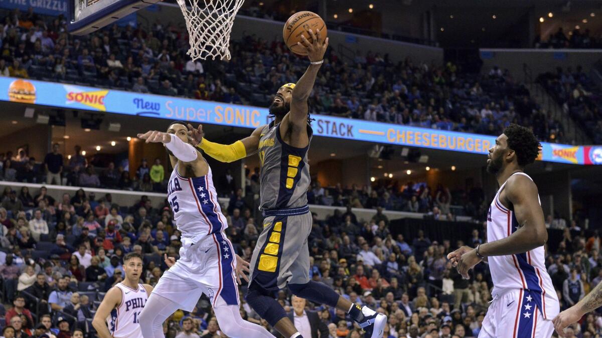 Memphis Grizzlies guard Mike Conley (11) drives for a layup against Philadelphia 76ers guard Ben Simmons (25) in the second half.