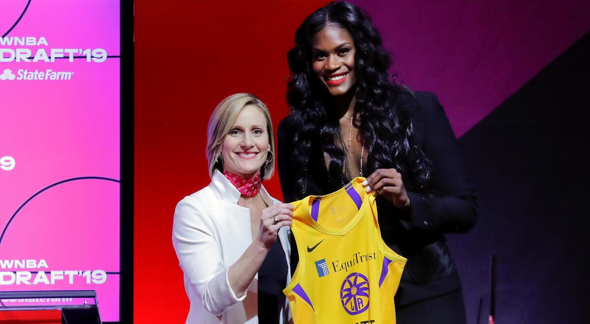 Kalani Brown, right, with WNBA Chief Operating Officer Christy Hedgpeth after being selected by the Sparks.