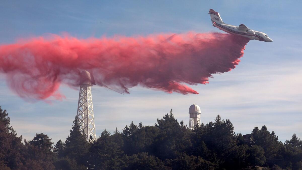 An air tanker makes a fire retardant drop on the brush fire near Mt. Wilson on Tuesday morning.