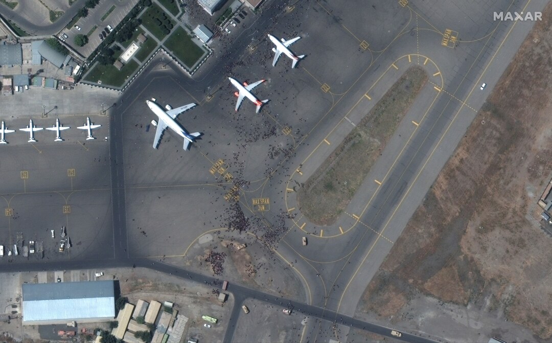 This satellite photo shows a large number of people on the tarmac at Kabul's international airport.