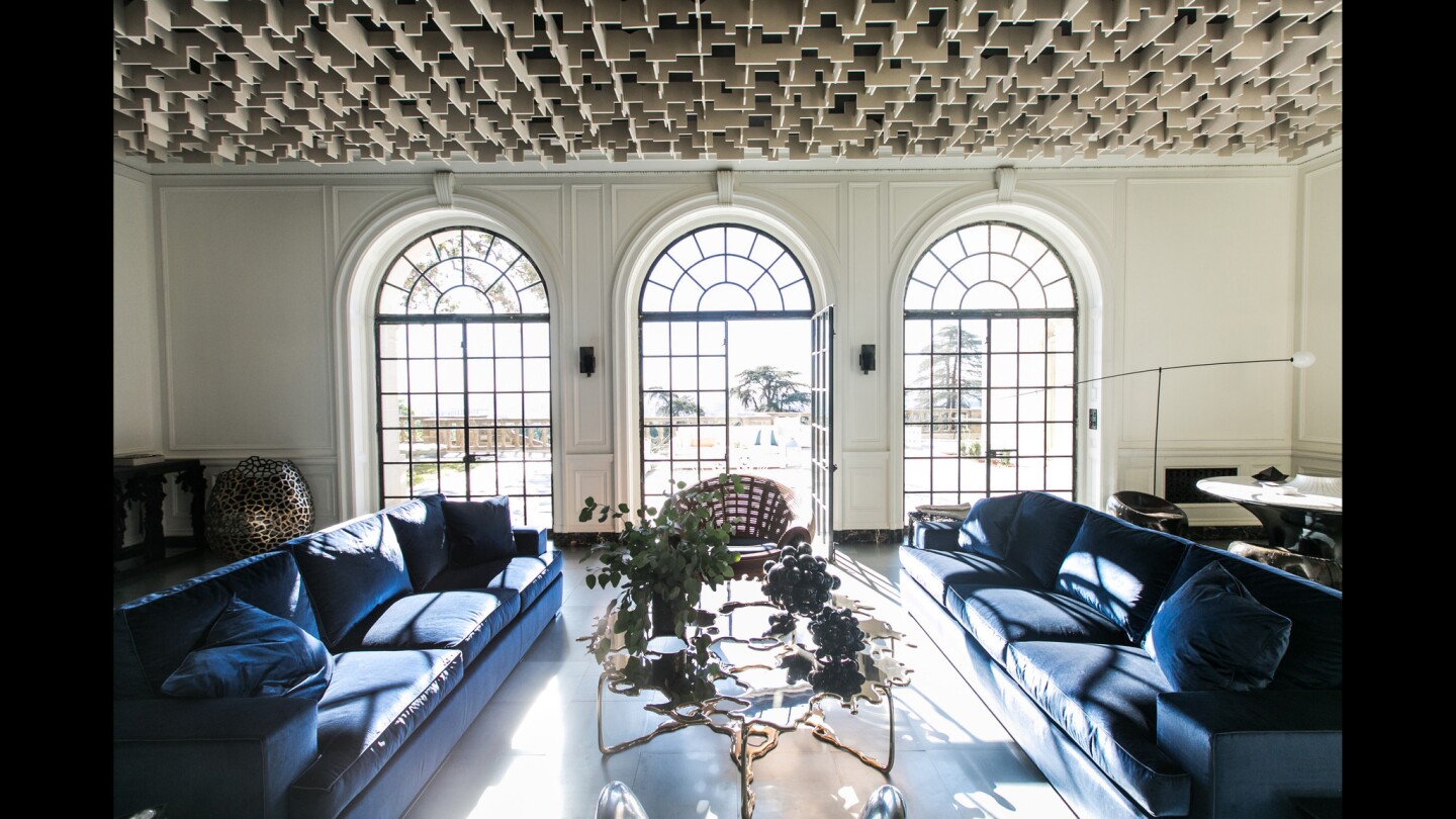 On the first floor of the historic Greystone Mansion in Beverly Hills, designer Oliver M. Furth has re-envisioned the reception hall with a ceiling of recycled plastic and steel tile flooring.