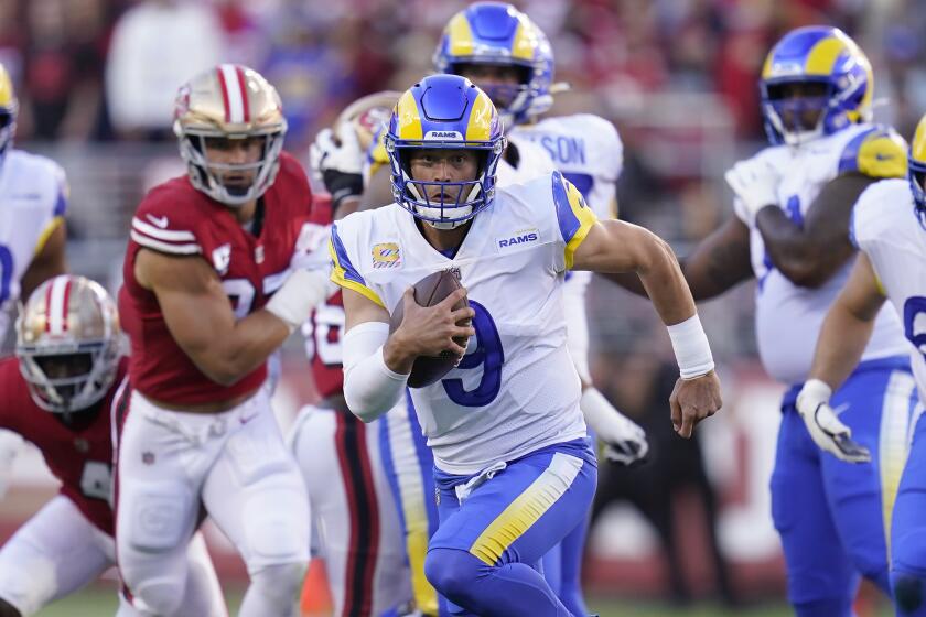 Los Angeles Rams quarterback Matthew Stafford (9) scrambles against the San Francisco 49ers.