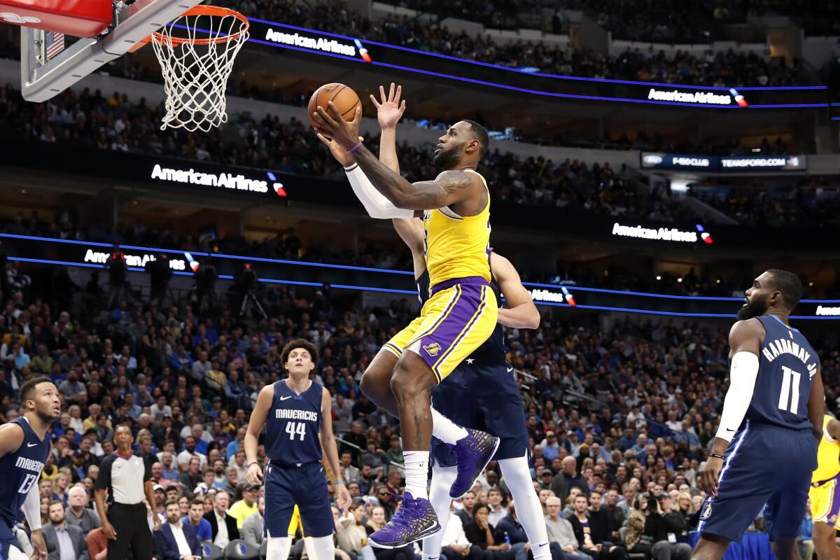 The Lakers' LeBron James goes up for a shot Friday night against the Mavericks.
