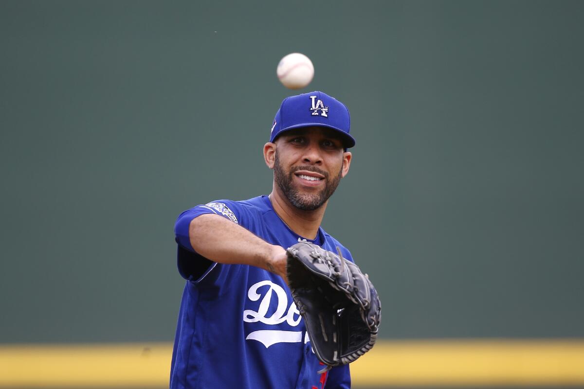 Dodgers starting pitcher David Price warms up during spring training.