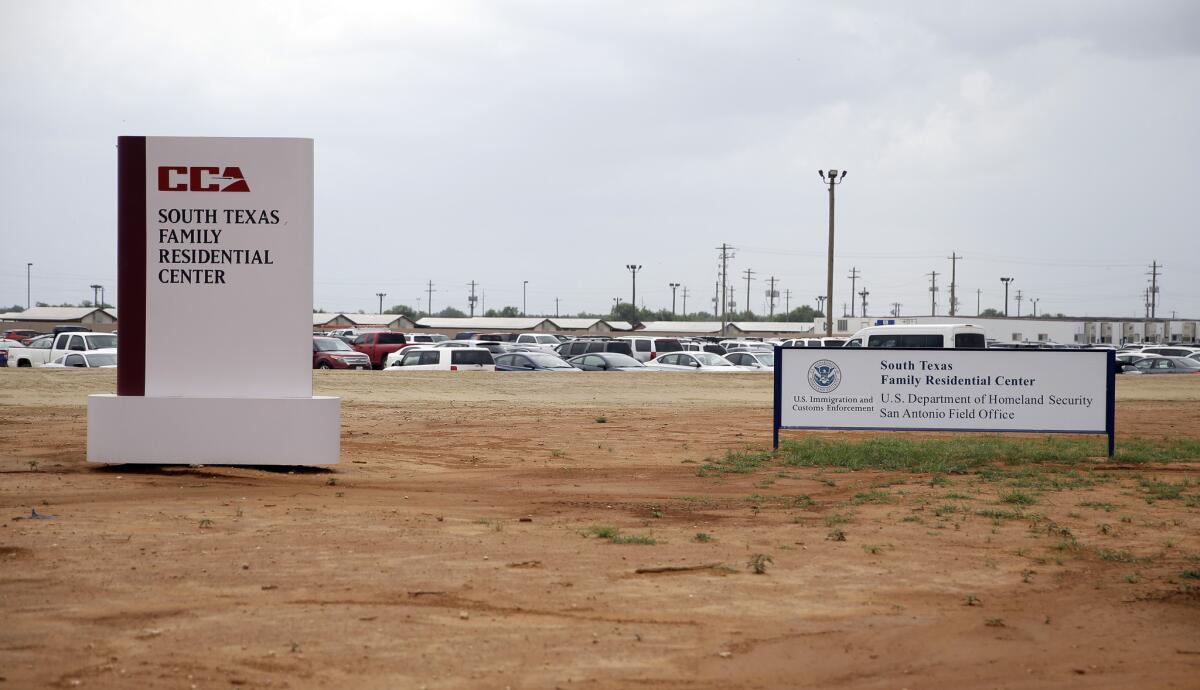 Signs are seen at the entrance to the South Texas Family Residential Center in Dilley, Texas, on June 30.