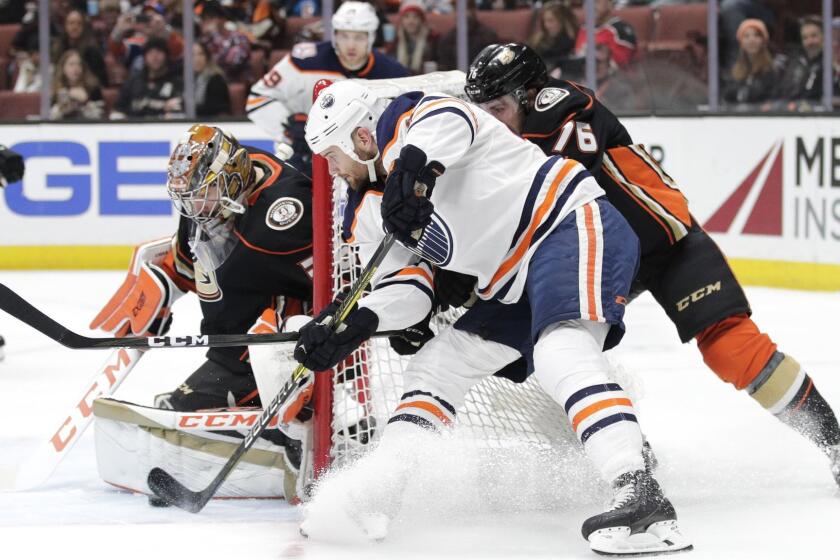 Anaheim Ducks goaltender John Gibson, left, stops a shot by Edmonton Oilers' Zack Kassian during the first period of an NHL hockey game Sunday, Jan. 6, 2019, in Anaheim, Calif. (AP Photo/Jae C. Hong)