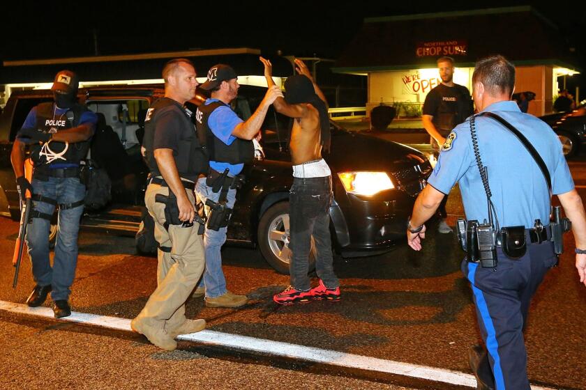 A protester is arrested on West Florissant Avenue in Ferguson, Mo., on Aug. 20