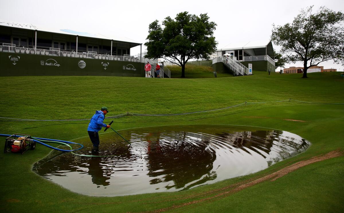 A member of the grounds crew works May 29 to remove standing water on the 17th hole at the TPC Four Seasons Las Colinas Golf Course after heavy rains delayed the second round of the Byron Nelson Championship in Irving, Texas.