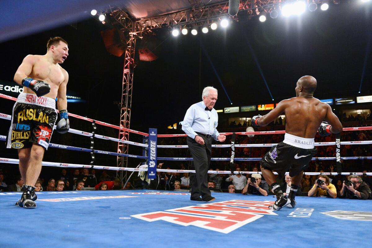 Timothy Bradley, right, is knocked down in the first round by Ruslan Provodnikov during their match at the Home Depot Center, now known as Dignity Health Sports Park, in Carson.