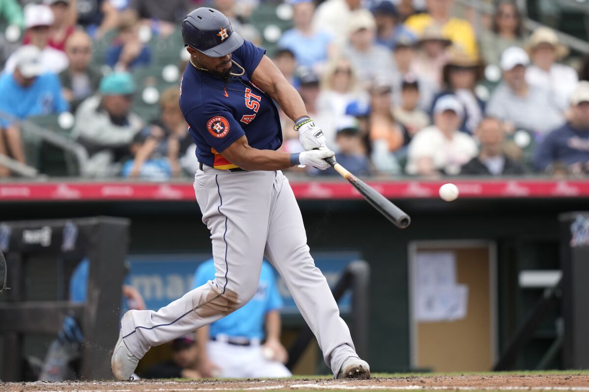 Houston Astros' Jose Abreu hits a double to score Jeremy Pena during the fourth inning of a spring training baseball game against the Miami Marlins, Sunday, March 19, 2023, in Jupiter, Fla. (AP Photo/Lynne Sladky)