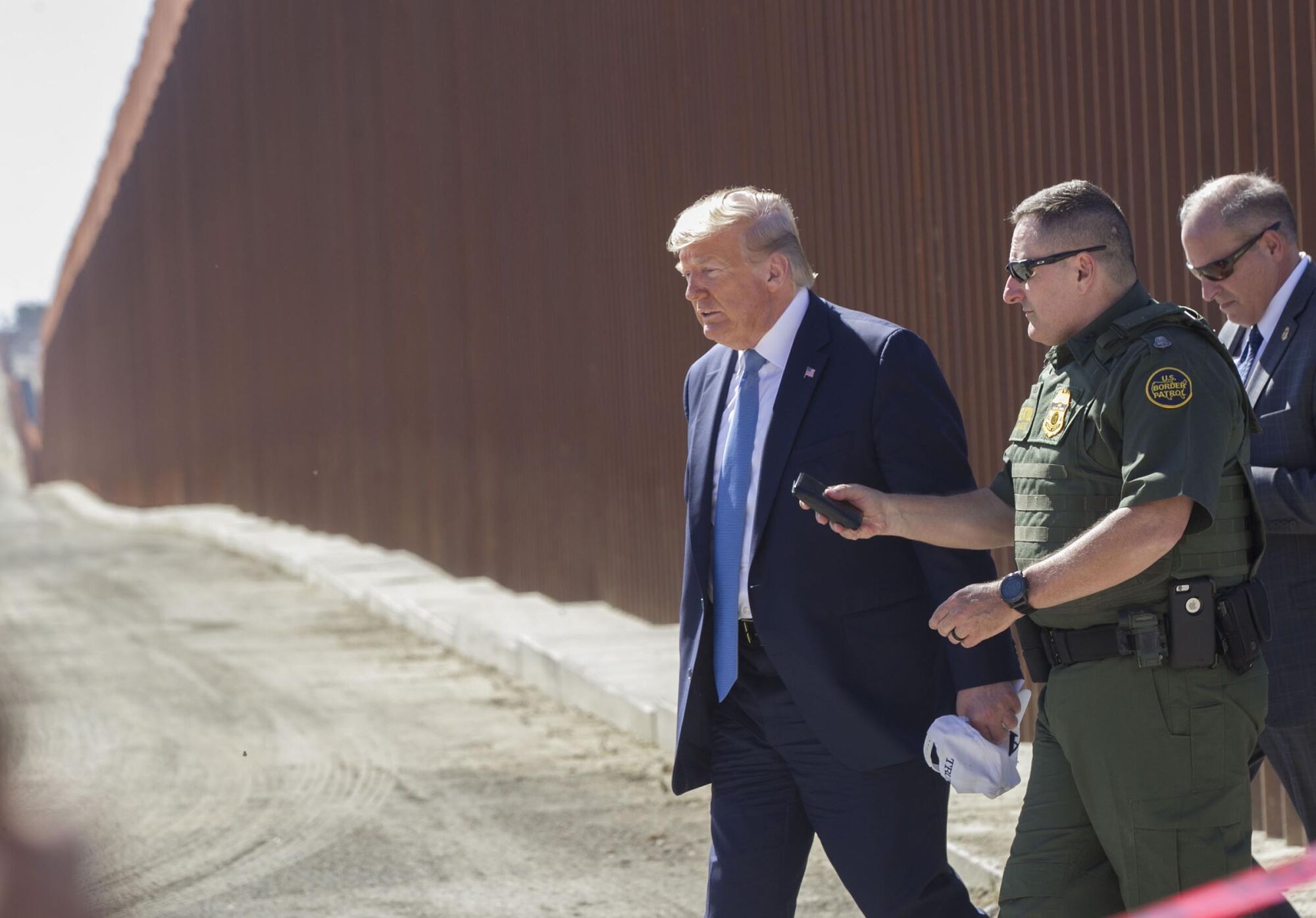 President Trump and acting San Diego Sector Chief Agent Douglas Harrison walked between the border fences