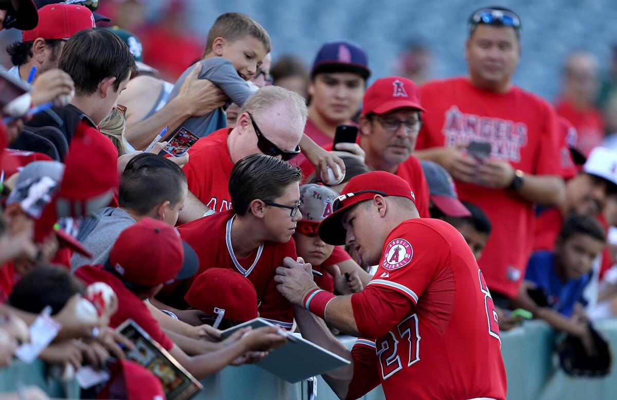 Mike Trout interacts with fans before Wednesday's game against Oakland.