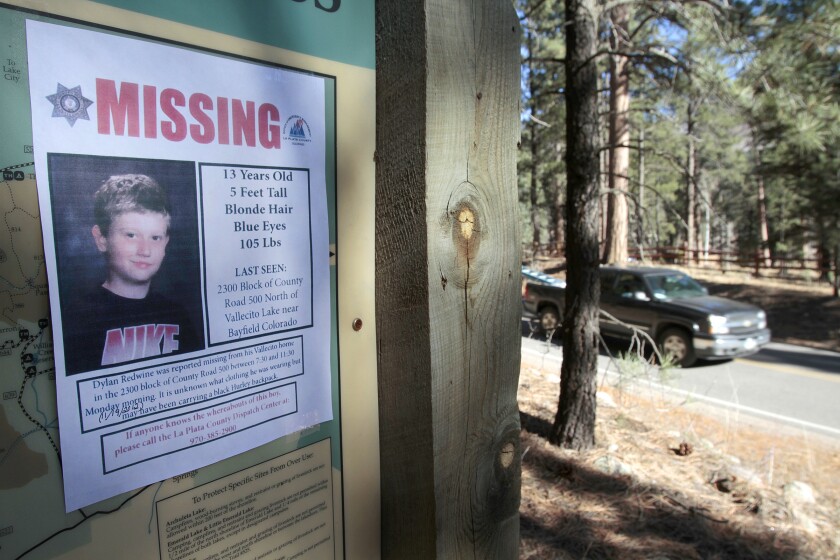 FILE - In this Nov. 26, 2012, file photo, a missing poster of 13-year-old Dylan Redwine hangs on a trail head sign next to Vallecito Reservoir in Vallecito, Colo. Prosecutors told a jury in closing arguments Thursday, July 15, 2021, that a Colorado father charged with killing his son almost a decade ago committed the deed after the 13-year-old boy learned things about his father that ultimately ruined their relationship. Mark Redwine, 59, is on trial on charges of second-degree murder and child abuse resulting in the death of Dylan Redwine. (Shaun Stanley/The Durango Herald via AP, File)