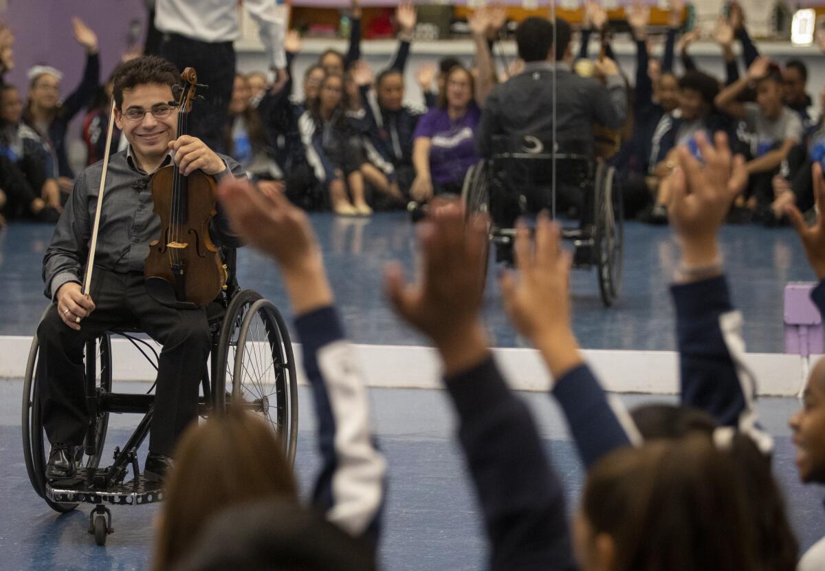 Niv Ashkenazi talks to students at Patrick Henry Middle School in Granada Hills about the Violins of Hope project