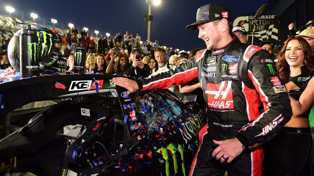 Kurt Busch affixes the winner's decal to his car in Victory Lane after winning the Daytona 500 on Sunday.